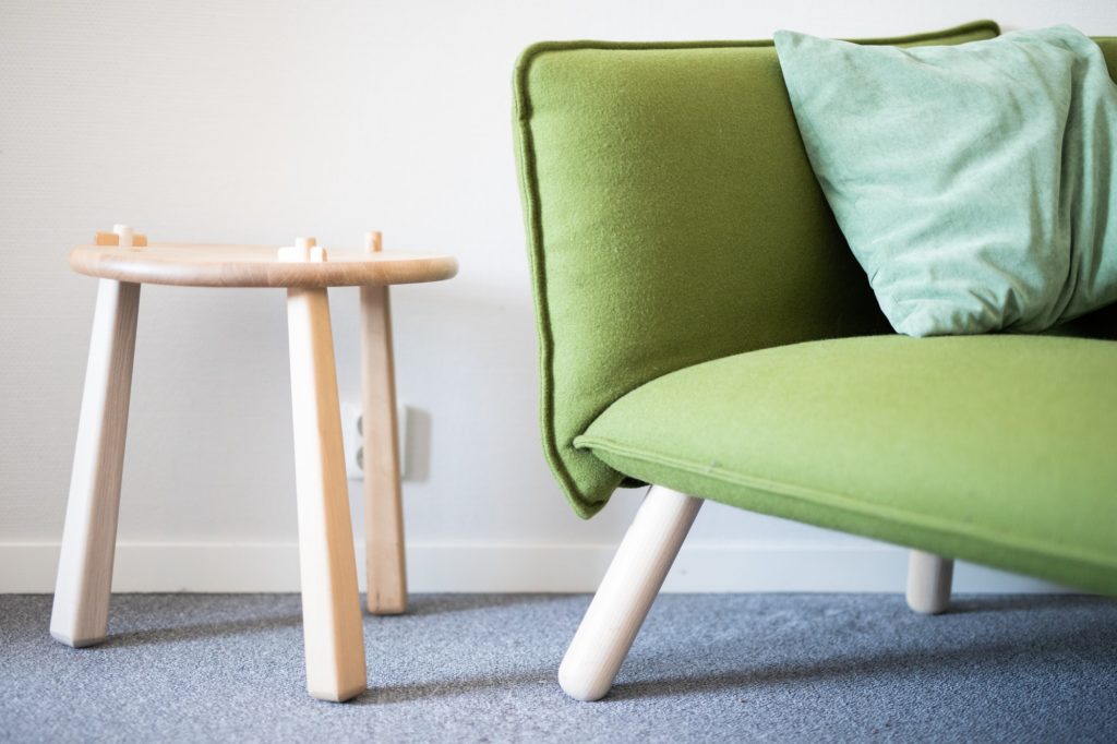 Green scandi style lounge couch and berch wood side table